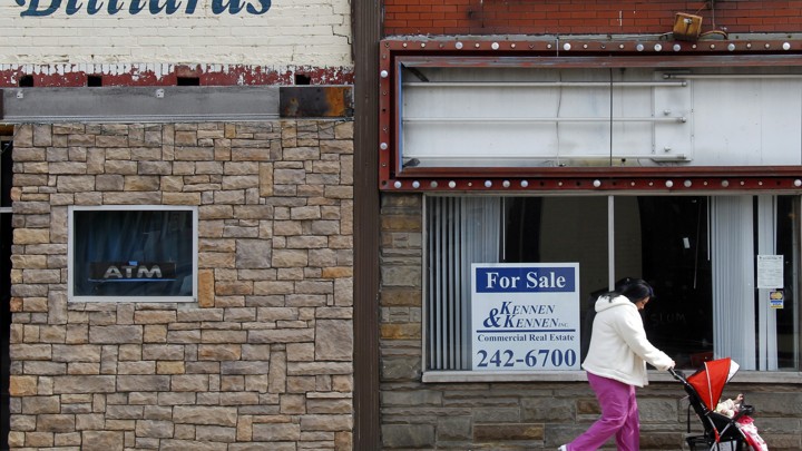 A woman pushes a baby carriage in the Rust Belt town of Wheeling, West Virginia.