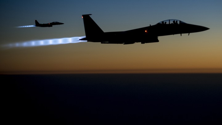 A pair of U.S. Air Force F-15E Strike Eagles fly over northern Iraq after conducting airstrikes in Syria on September 23, 2014.