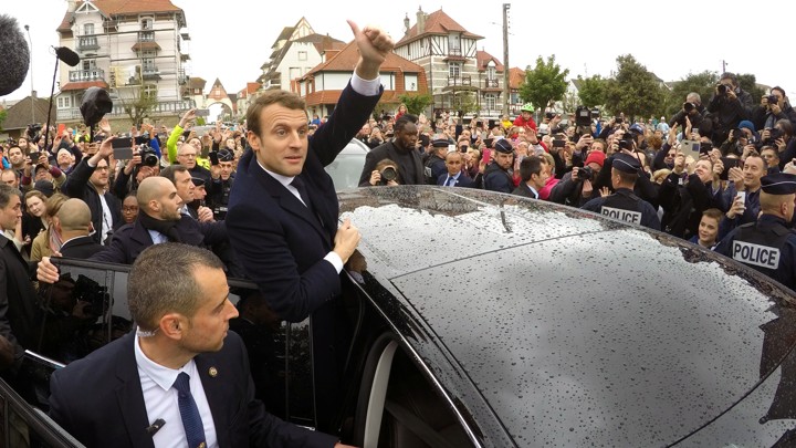 French presidential election candidate Emmanuel Macron greets supporters as he leaves a polling station on May 7, 2017.