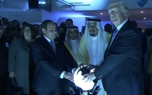 Donald Trump places his hands on a glowing orb in Riyadh, Saudi Arabia, in May 2017.