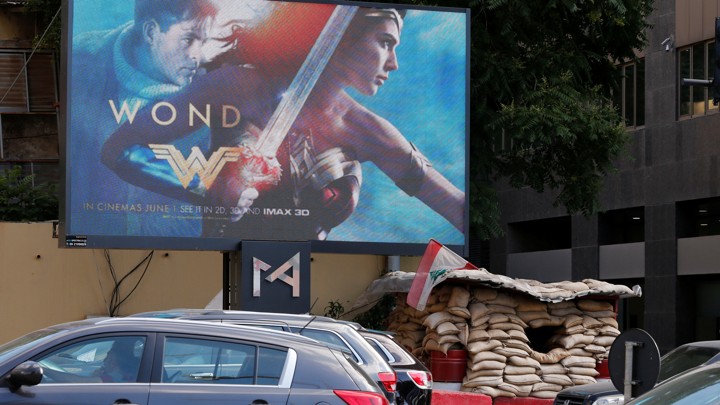 An billboard advertising the "Wonder Woman" film, which was banned in Lebanon, is pictured near an army post in Beirut on May 31, 2017.