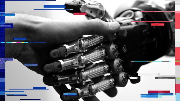 A man shakes hands with a humanoid robot during the International Conference on Humanoid Robots in Madrid, in 2014.