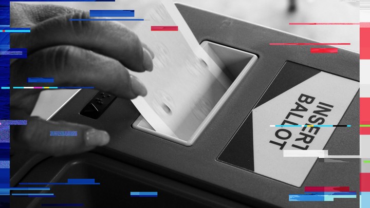 A woman inserts her ballot into an intake machine in Los Angeles, in 2012.