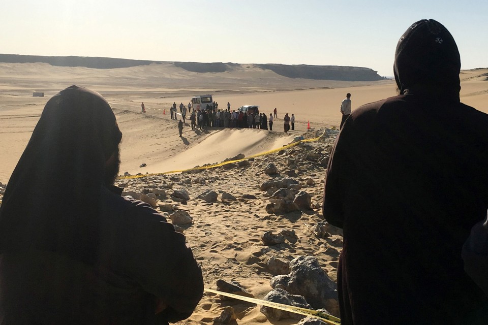 Monks survey the view following an attack on Coptic Christians traveling to a monastery in Minya, Egypt