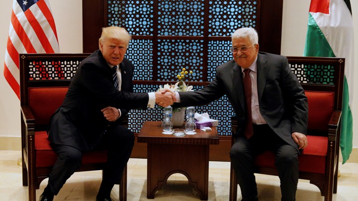 U.S. President Donald Trump shakes hands with Palestinian President Mahmoud Abbas during their meeting at the presidential headquarters in the West Bank town of Bethlehem on May 23, 2017.