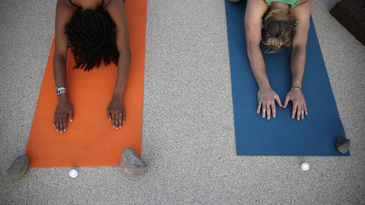 Two people practice yoga