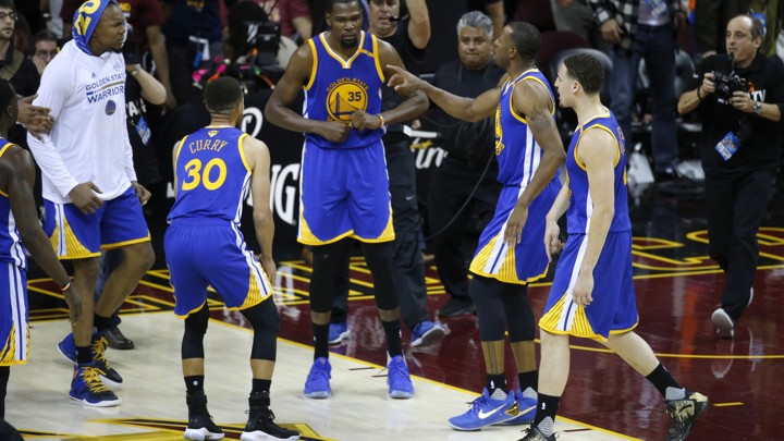 Golden State Warriors forward Kevin Durant celebrates with teammates after the Warriors defeated the Cleveland Cavaliers 118-113 in Game 3 of the NBA Finals in Cleveland, Wednesday, June 7, 2017.