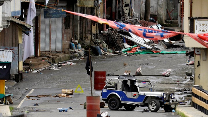 An ISIS flag hangs over the Maute group stronghold in southern Philippines on May 29, 2017.