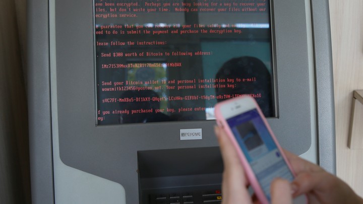 A message demanding money is seen on a monitor of a payment terminal at a branch of Ukraine's state-owned bank Oschadbank after Ukrainian institutions were hit by a wave of cyberattacks on June 27, 2017.
