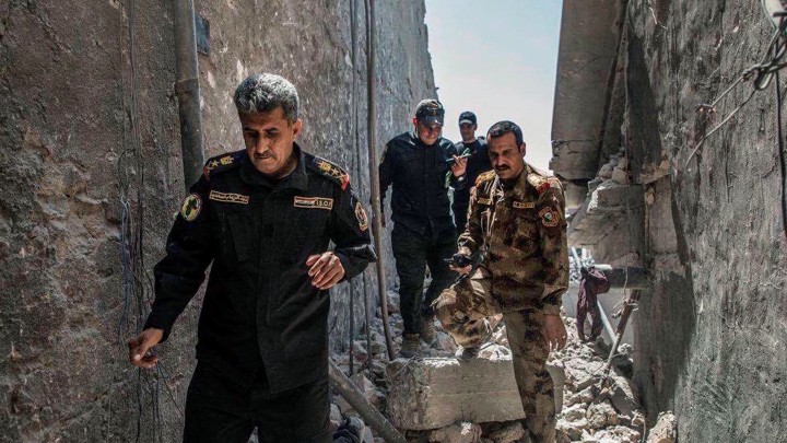 Iraqi officers pictured on the ruins of the Grand al-Nuri Mosque in Mosul, Iraq on June 29, 2017.