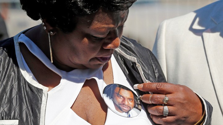 Valerie Castile, the mother of Philando Castile, looks at a photo button of her son in Saint Paul.