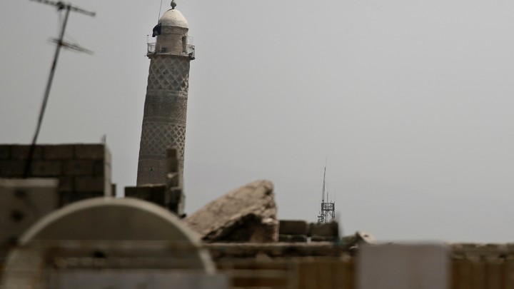 An ISIS flag hangs from Mosul's Al-Habda minaret at the Grand Mosque of al-Nuri in western Mosul on May 29, 2017.