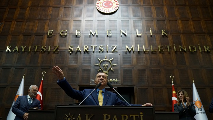 Turkish President Tayyip Erdogan greets members of parliament from AKP during a meeting at the Turkish parliament in Ankara, Turkey, on May 30, 2017.