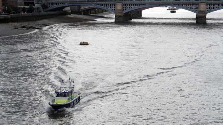 A police boat drives along the River Thames towards the London Bridge on June 6, 2017.