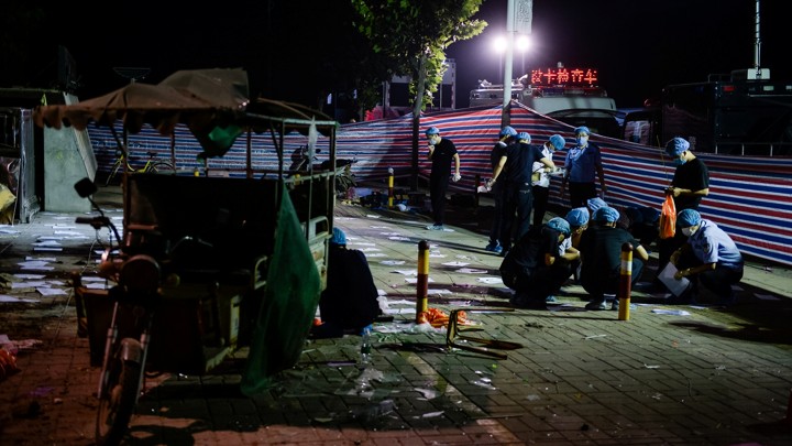 Forensic experts work at the site of the explosion in Xuzhou City on June 16, 2017.