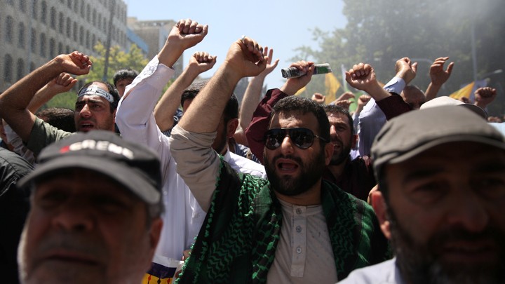 People attend a funeral for the victims of the June 7 attacks in Tehran.
