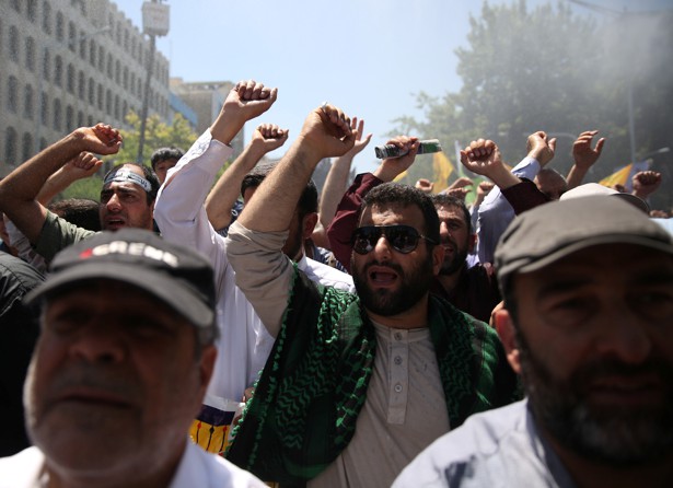 People attend a funeral for the victims of the June 7 attacks in Tehran.