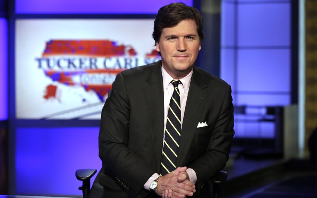 Tucker Carlson, host of "Tucker Carlson Tonight," looks at the camera.