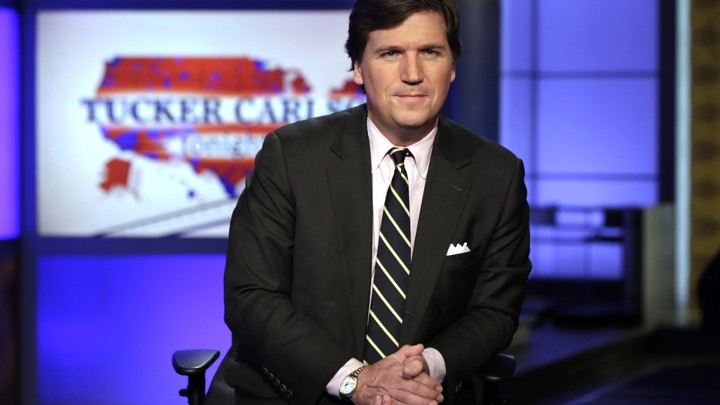 Tucker Carlson, host of "Tucker Carlson Tonight," looks at the camera.