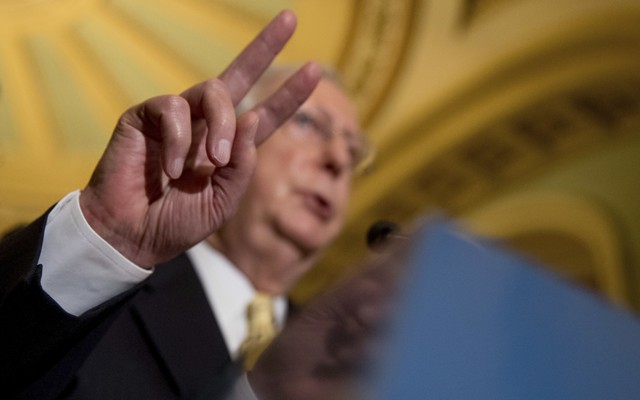 Senate Majority Leader Mitch McConnell gestures while speaking at a July news conference on Capitol Hill.