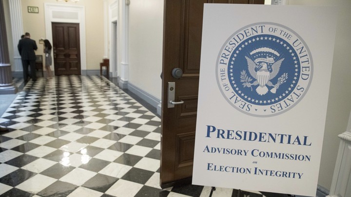 A sign advertising the voter-fraud commission outside of its first meeting