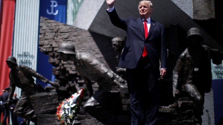 U.S. President Donald Trump waves on stage in front of a national monument before his speech in Warsaw, Poland