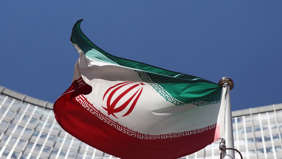 An Iranian flag flutters in front of the United Nations headquarters.