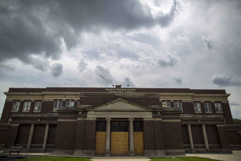 An abandoned, boarded up building in Chicago that two years before this photo was taken housed a school that was later closed
