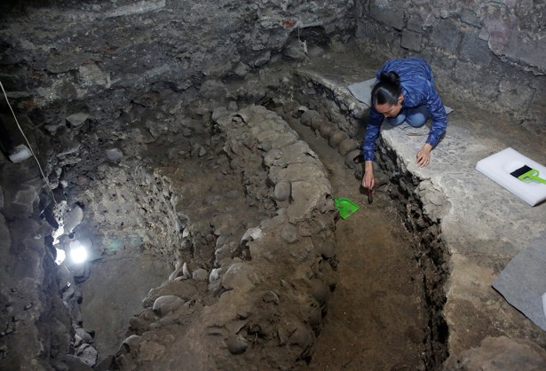 Lorena Vazquez, an archaeologist from the National Institute of Anthropology and History (INAH), works at a site where more than 650 skulls caked in lime and thousands of fragments were found in the cylindrical edifice near Templo Mayor.
