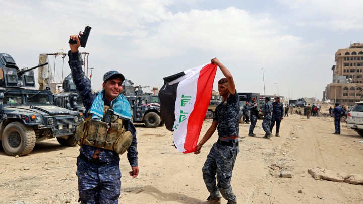 Iraqi Federal Police celebrate in the Old City of Mosul.