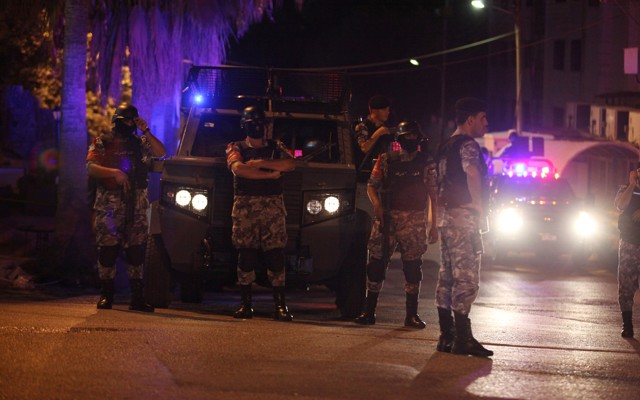 Policemen are seen near the Israeli embassy in Amman.