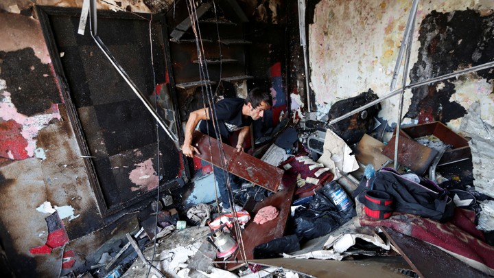 An Afghan shopkeeper inspects his shop after a suicide attack Monday in Kabul. More than 15 years after it was ousted by a U.S.-led invasion, the Taliban remains a potent force in Afghanistan.