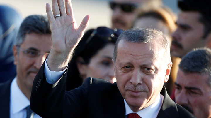 Turkey's president waves as he arrives for the G20 leaders summit in Hamburg, Germany on July 6, 2017.