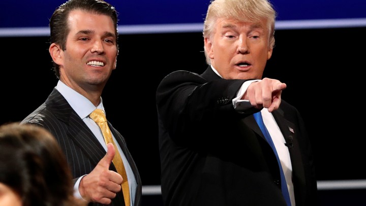 Donald Trump Jr. gives a thumbs up beside his father Donald Trump.