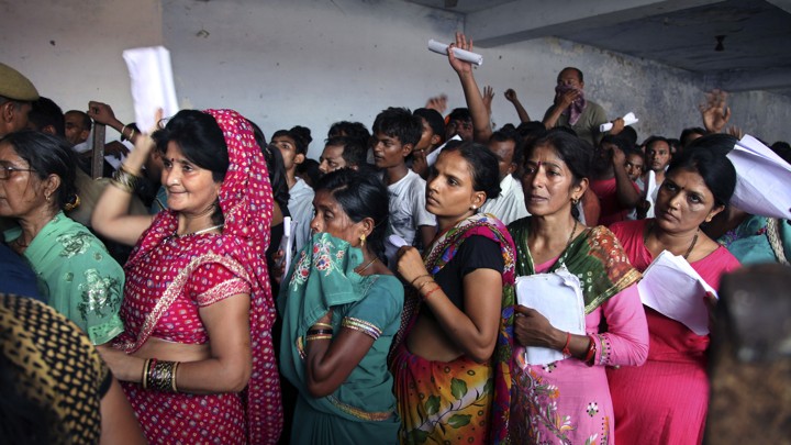 Indian Hindu devotees stand in a queue to register for a pilgrimage to the Hindu holy site of Amarnath on July 2, 2015.