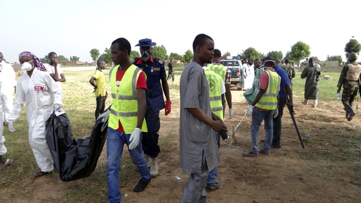 Rescue workers attend to the scene following the suicide bombings on July 12, 2017.