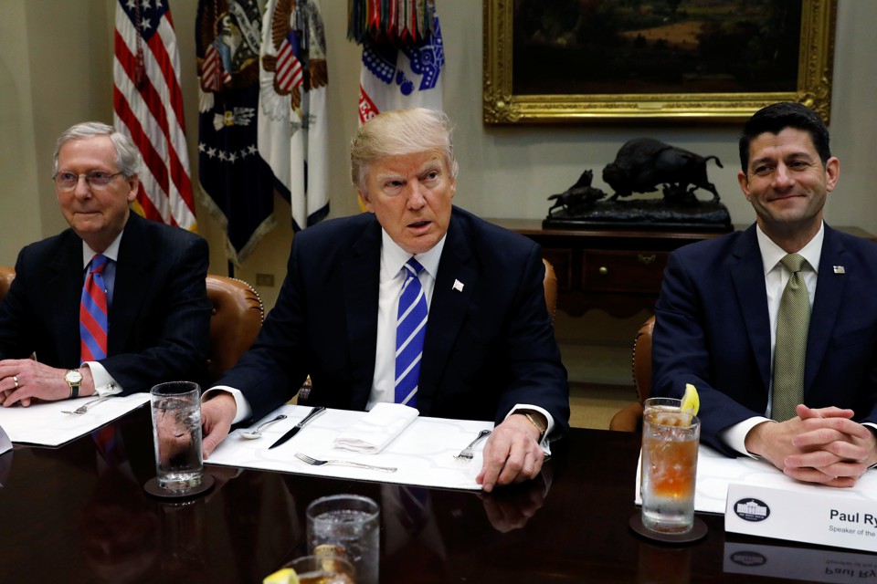 Mitch McConnell, Donald Trump, and Paul Ryan sit at dinner together.