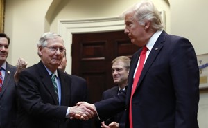 Mitch McConnell and President Trump shake hands.