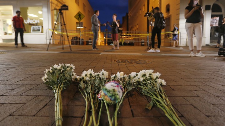 Flowers and other mementos are left at a makeshift memorial for the victims after a car plowed into a crowd of people protesting in Charlottesville, Virginia.