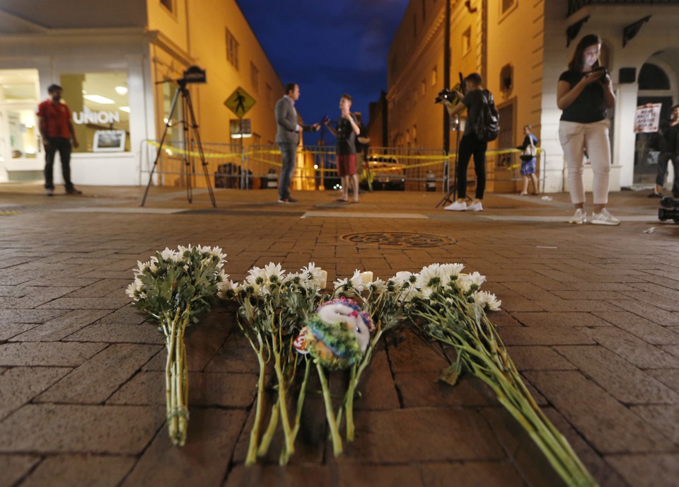 Flowers and other mementos are left at a makeshift memorial for the victims after a car plowed into a crowd of people protesting in Charlottesville, Virginia.