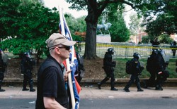 A white nationalist is seen leaving Emancipation Park in Charlottesville, Virginia, where violent clashes took place between counter-protesters and white-nationalist groups. Hundreds of white nationalist gathered at the park for a “Unite The Right” rally to protest the removal of the statue of Robert E. Lee, which is seen in the background.