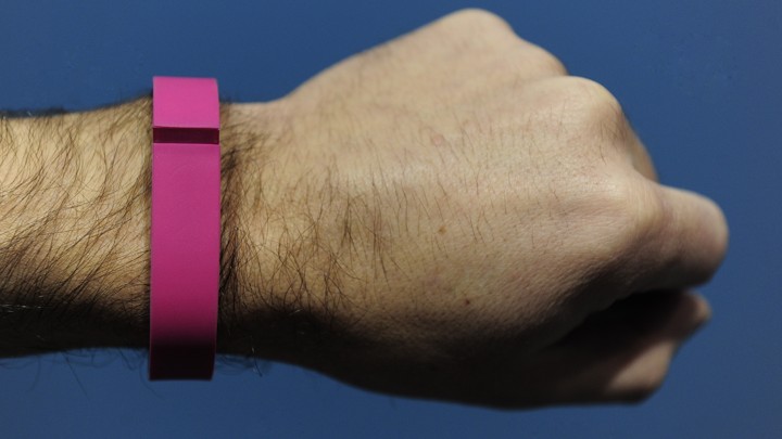 A person's arm with a fitness tracker on their wrist