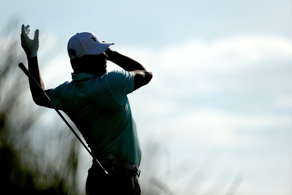 The professional golfer Gary Woodland loses grip of his club during a swing.