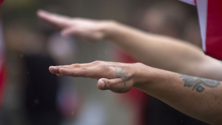 Two arms raised in Nazi salutes