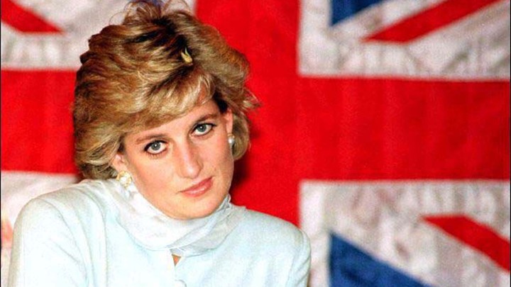 Princess Diana sitting in front of a British flag