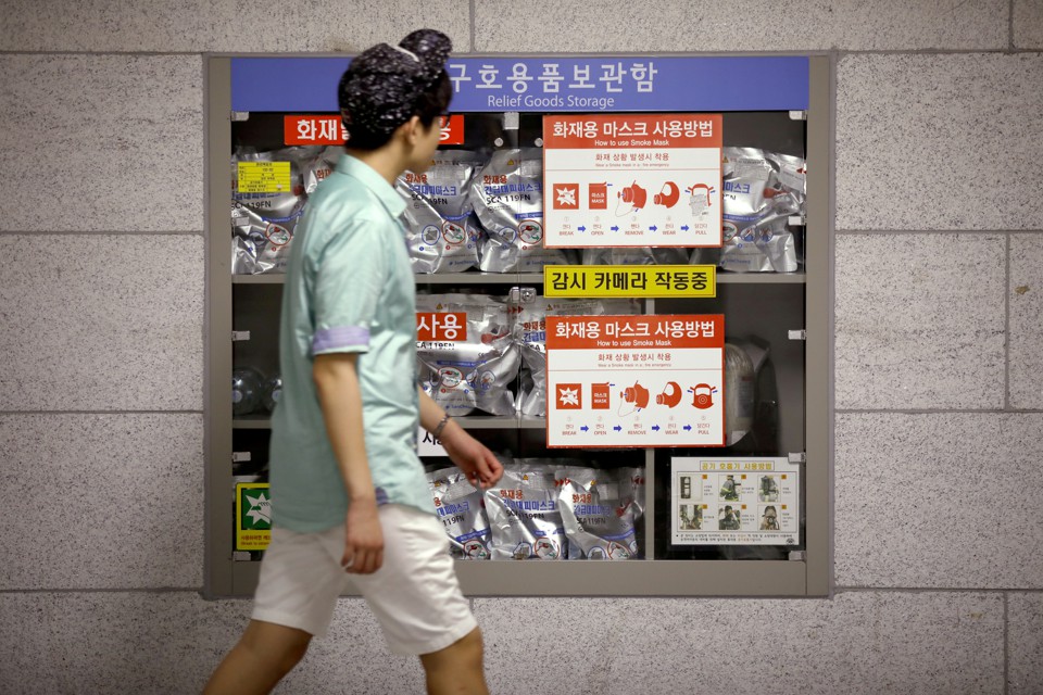 A young man walks in front of a relief goods storage inside of a subway in Seoul, South Korea.