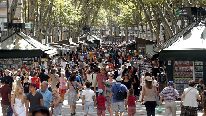 A crowd of people walks in Las Ramblas in Barcelona