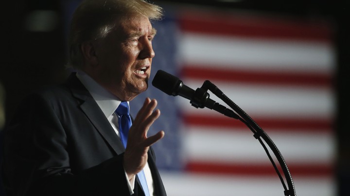President Trump speaks into a mic