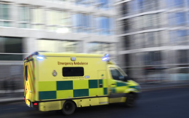 An ambulance speeds down a city street.