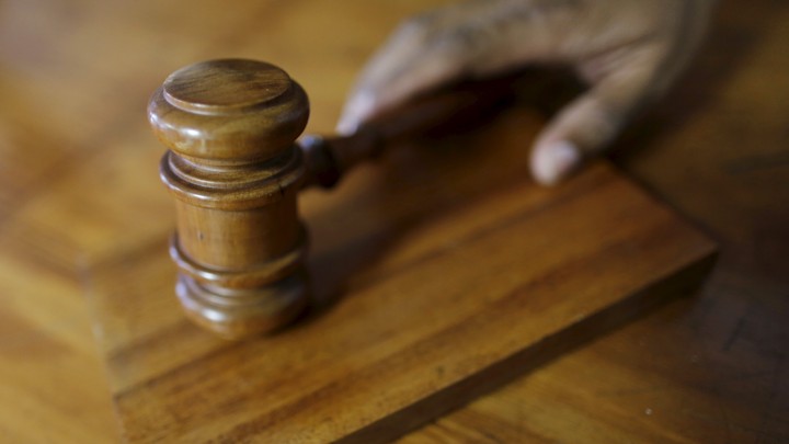 A gavel sits on a desk.